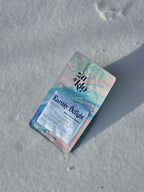 Image of Za & Klo coffee bag with reflective label. Coffee has notes of rose, pistachio, honey and orange blossom. Za and Klo's coffee named earthly delight.